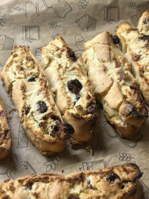 Crisp homemade cranberry nut biscotti laid out on decorative baking paper. Perfect for gourmet treats.
